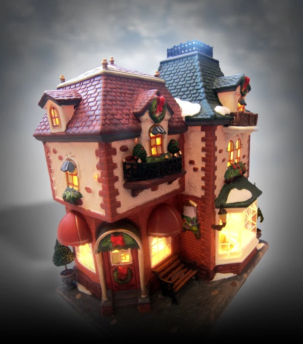 a small doll house with lights on is illuminated