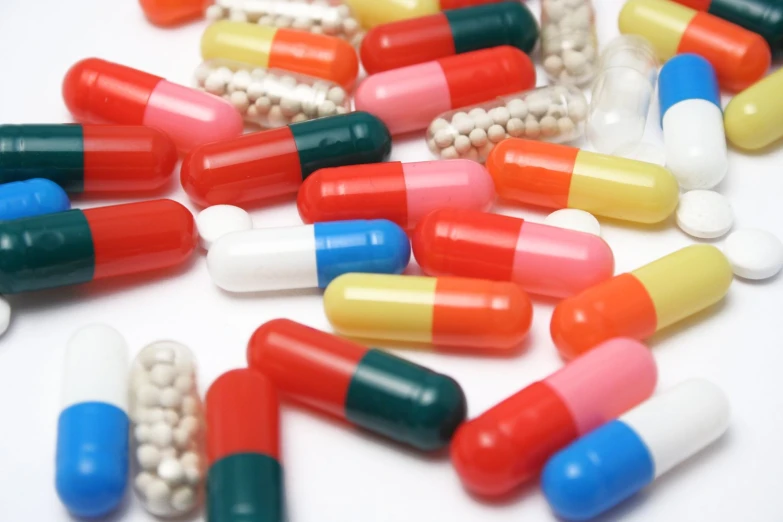 many colorful pills in an assortment are on the table