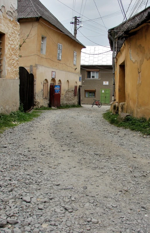 a street with many small buildings and cobblestones