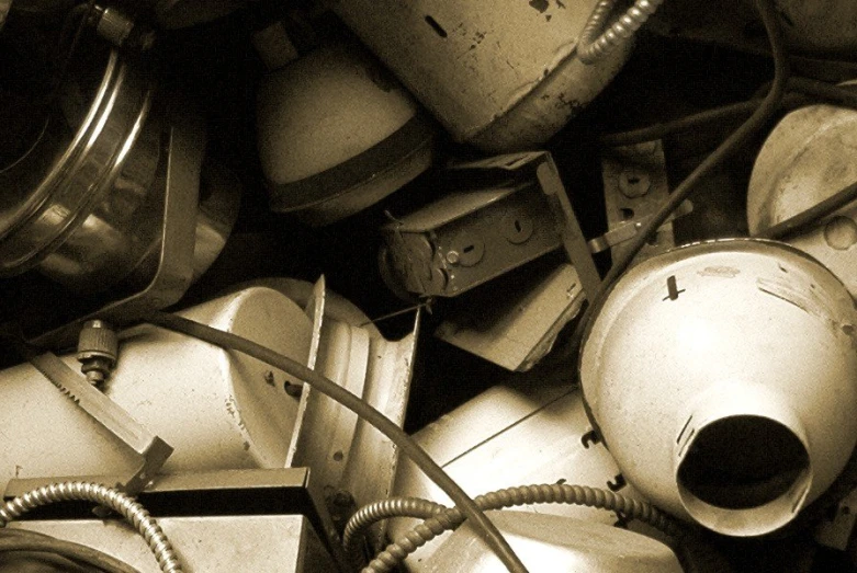 a pile of old broken out appliances, including old fashioned clocks