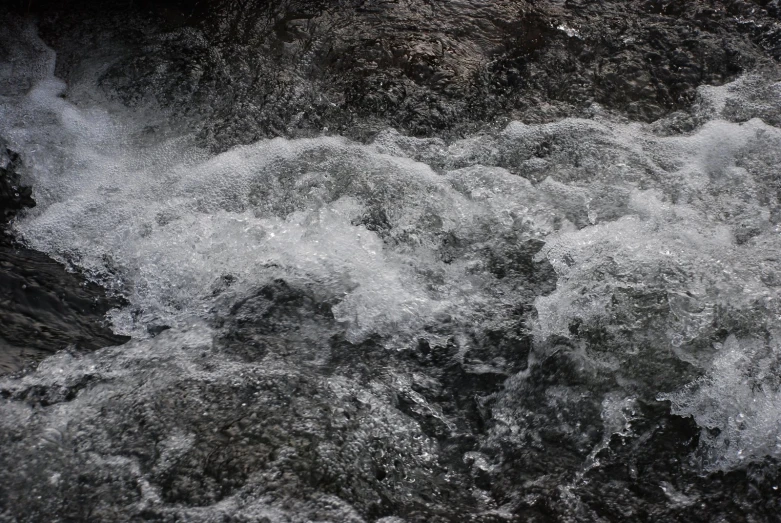 water gushing on rocks near shore during sunset