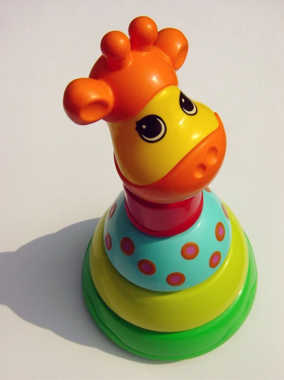 a toy giraffe that is on top of a stand