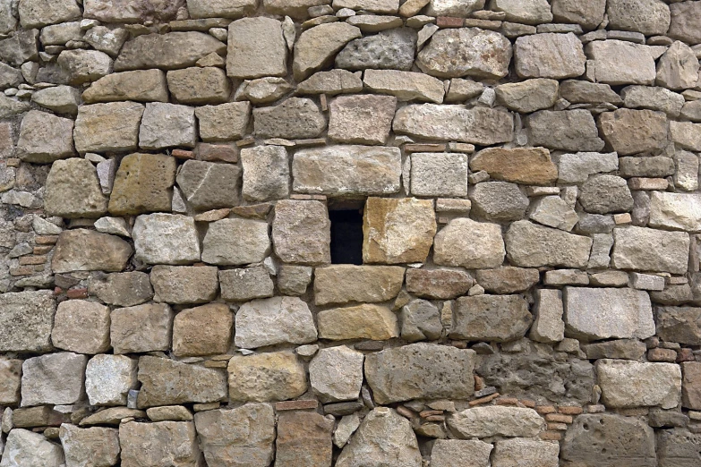 a stone wall with a hole built into it