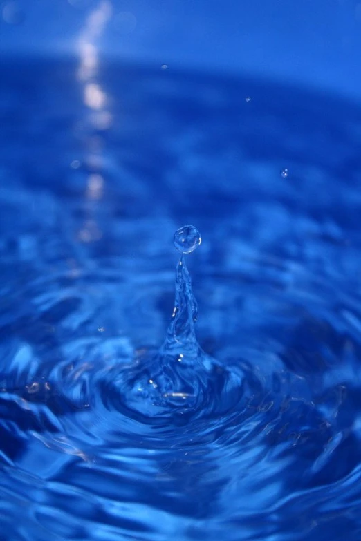 a blue liquid is coming out of the water