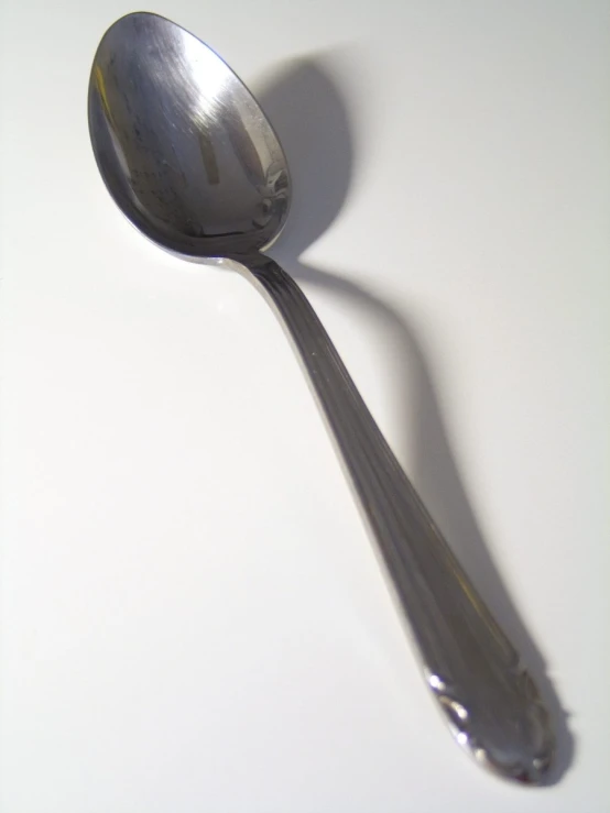 a spoon sitting on top of a white counter