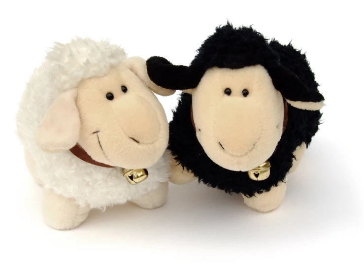 a stuffed sheep is next to an adult sheep