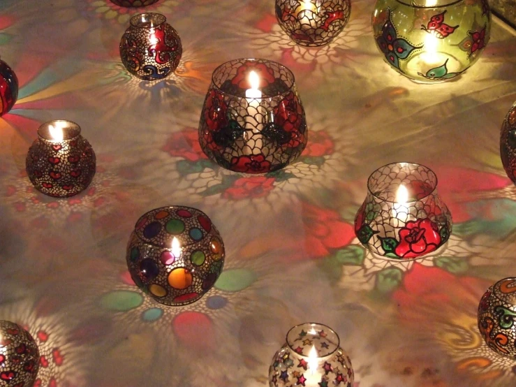 a group of small red glass candles are in a pattern