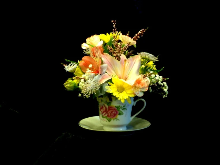 a cup filled with flowers sitting on a table