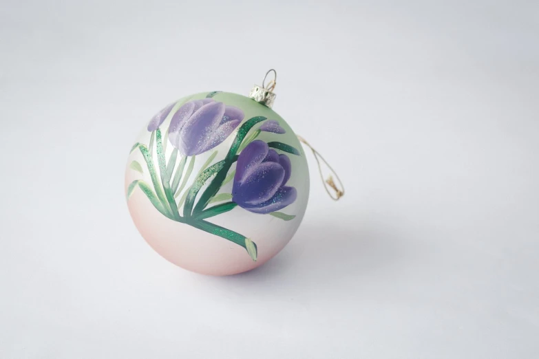 a floral ornament has purple flowers painted on it