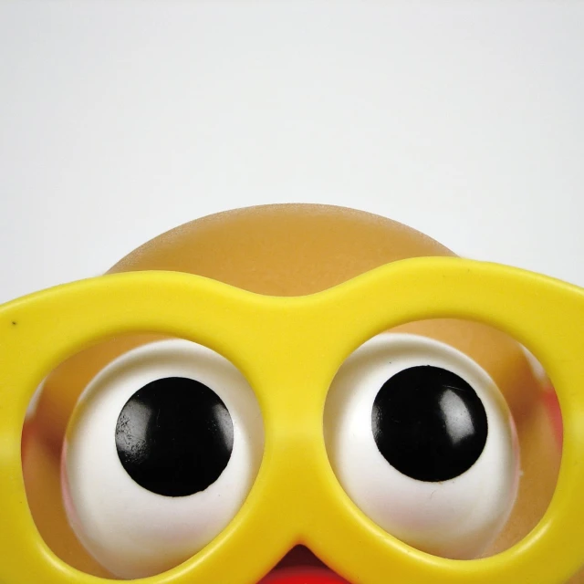 a toy head with an eyeball around its eyes