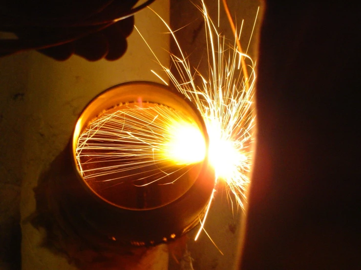 a close up of a person using welding equipment