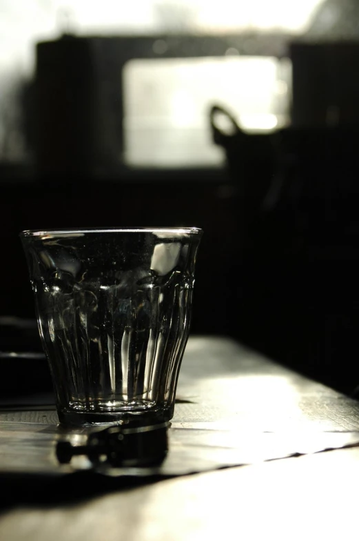 a glass cup is sitting on a table