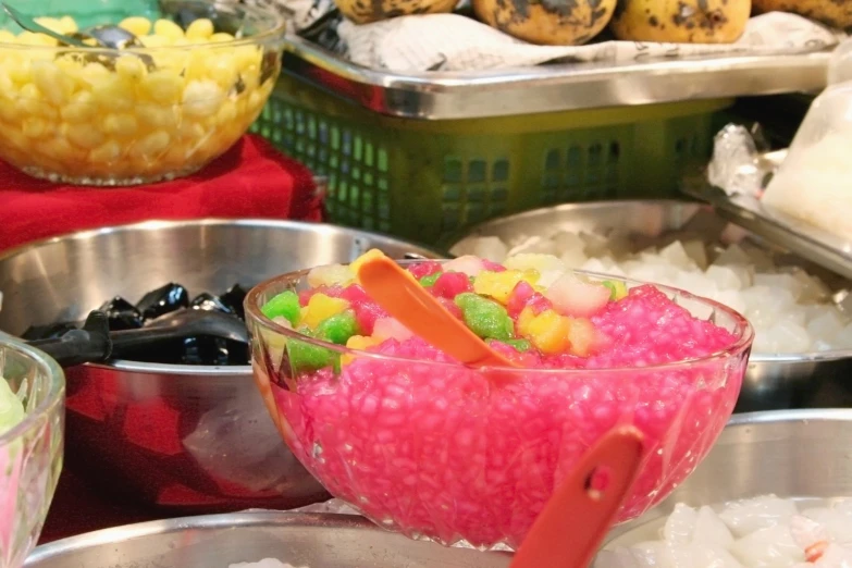 different food in metal pans on display