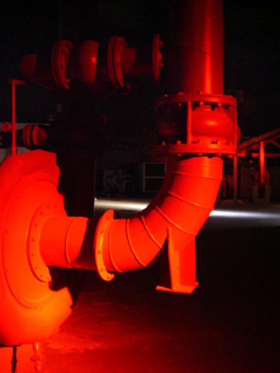 red colored pipe and pipes in dark area