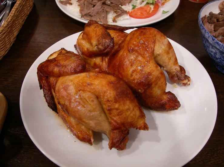 some chicken is laying on the table next to food