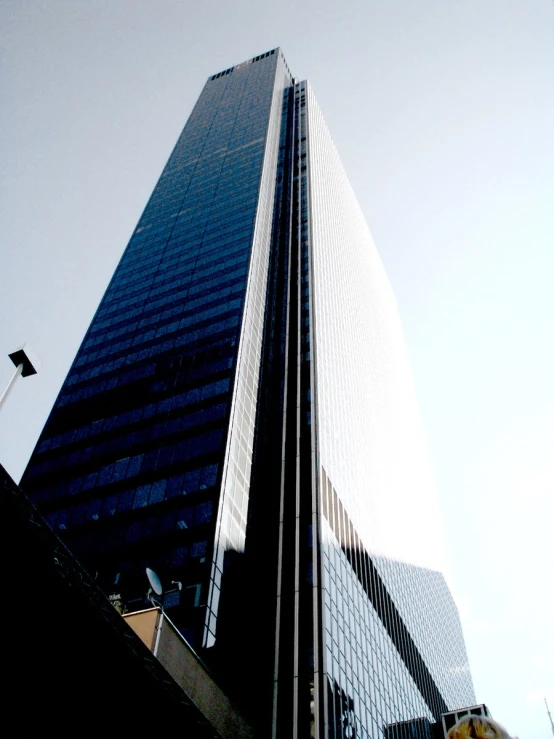 tall buildings on both sides with windows and a sky background