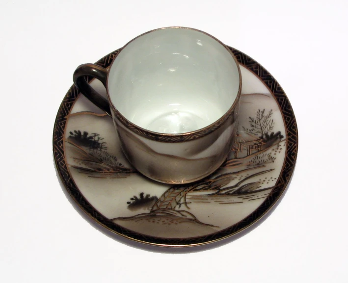 a plate that has an oriental teacup and saucer on it
