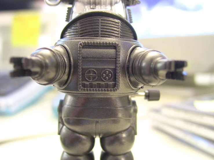 a close up view of a toy robot that is on a table
