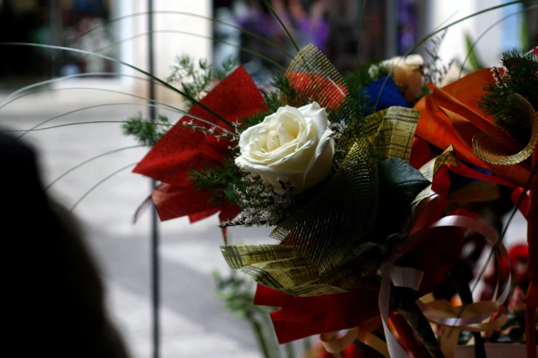 a bouquet is shown on a stand, complete with flowers