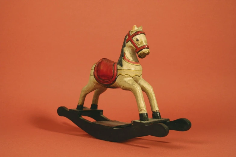 small toy horse in a plastic outfit on a skateboard