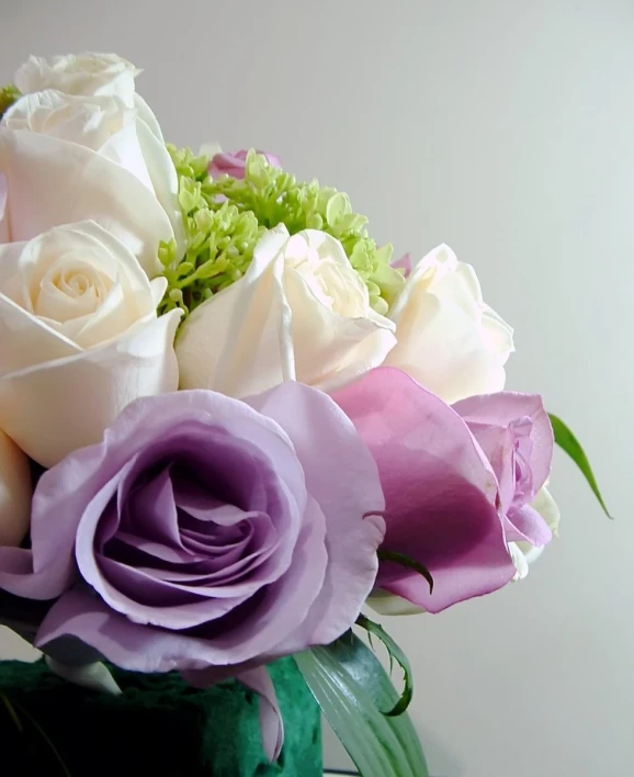 a vase with some pink and white flowers