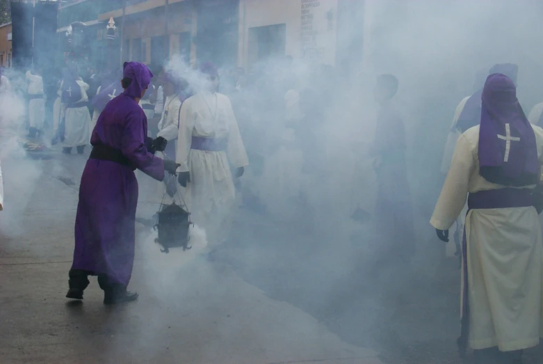 several people dressed in purple stand by the road