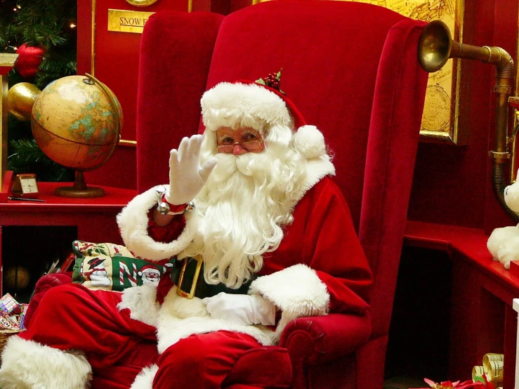 a man in a red chair dressed as santa claus