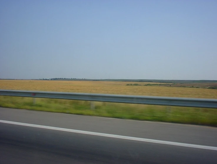 the field next to the highway is very empty