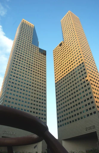 looking up at two office buildings in a city