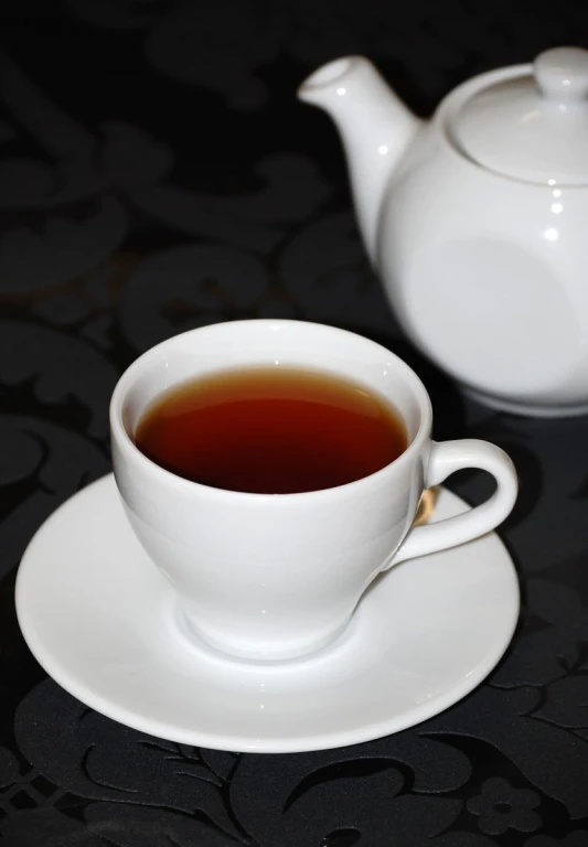 tea being prepared in a white teapot