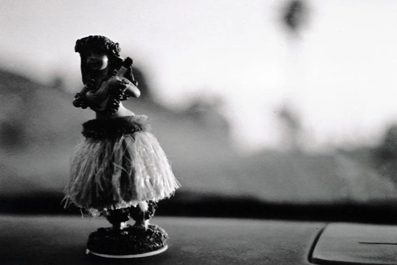a toy figurine with a tutu sitting on top of a table