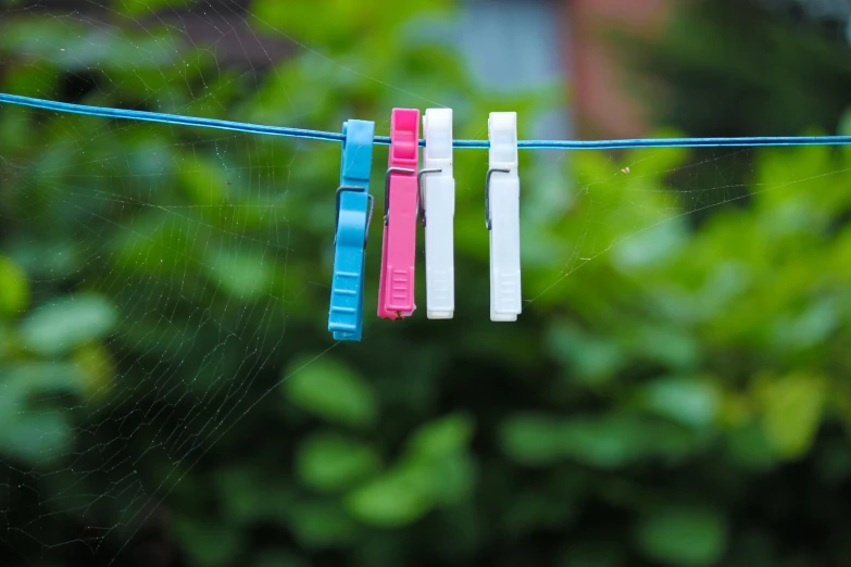 toothbrushes hanging out on a line in the rain