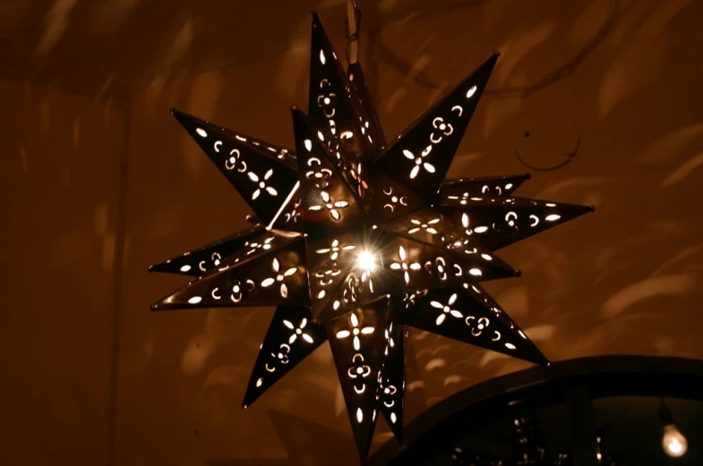 lighted christmas star hanging on a wall