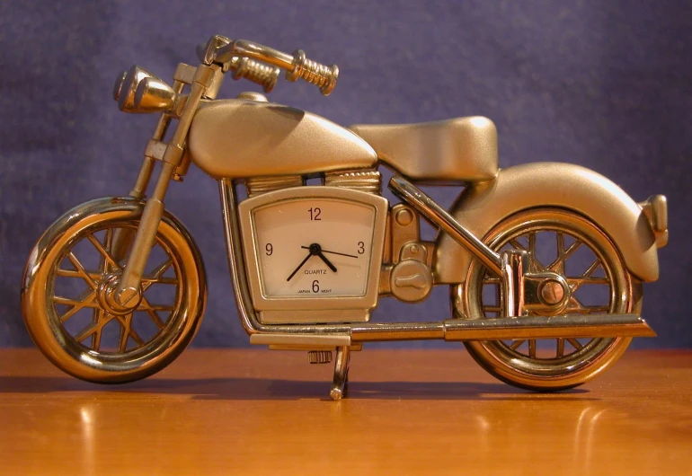 a gold motorcycle with a clock attached to it