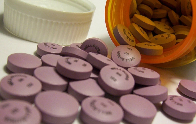 several pills and pill caps with the top half open