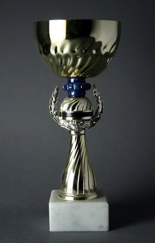 an ornate silver cup sitting on a table