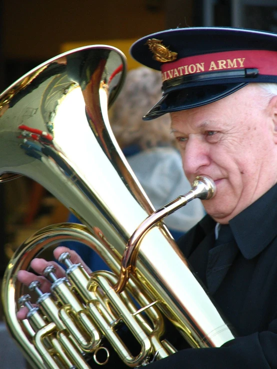 a soldier wearing a navy uniform playing his trumpet