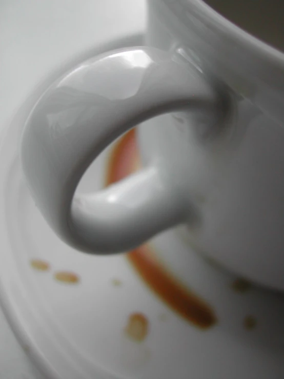 a tea cup with sauce dripping on it