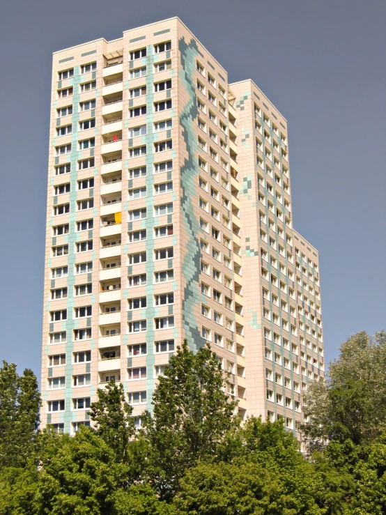 a tall white building with balconies in front of it