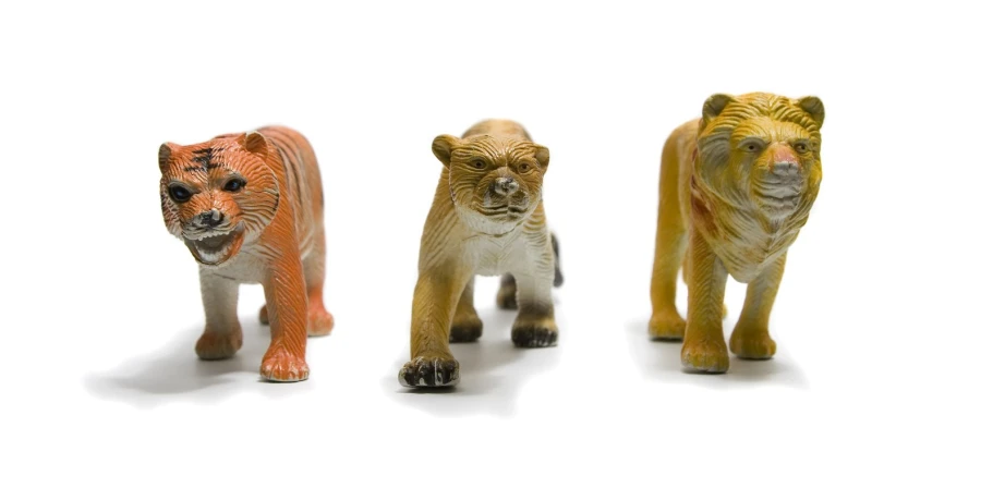 three toy figurines depicting various sized animals