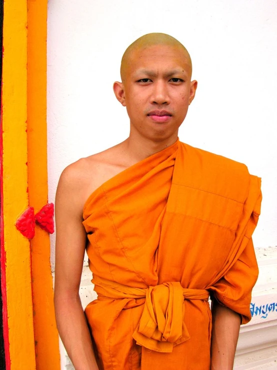 there is a young monk posing for the camera