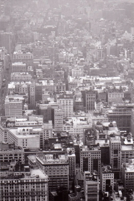 an aerial view of skyscrs and streets in a city