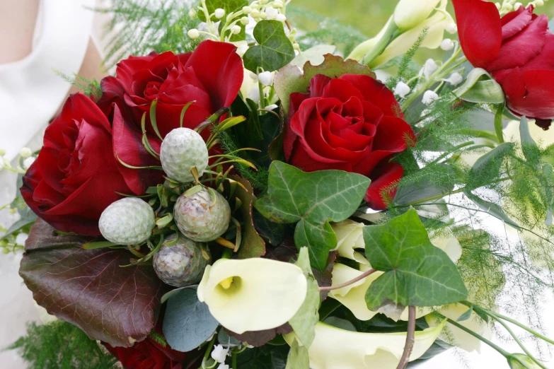 a bride holding her wedding bouquet in white and red