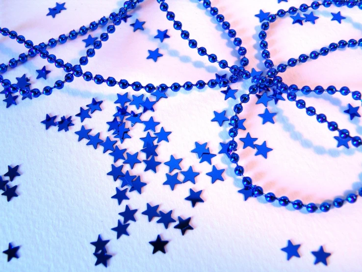 a white table topped with blue stars under a glass plate