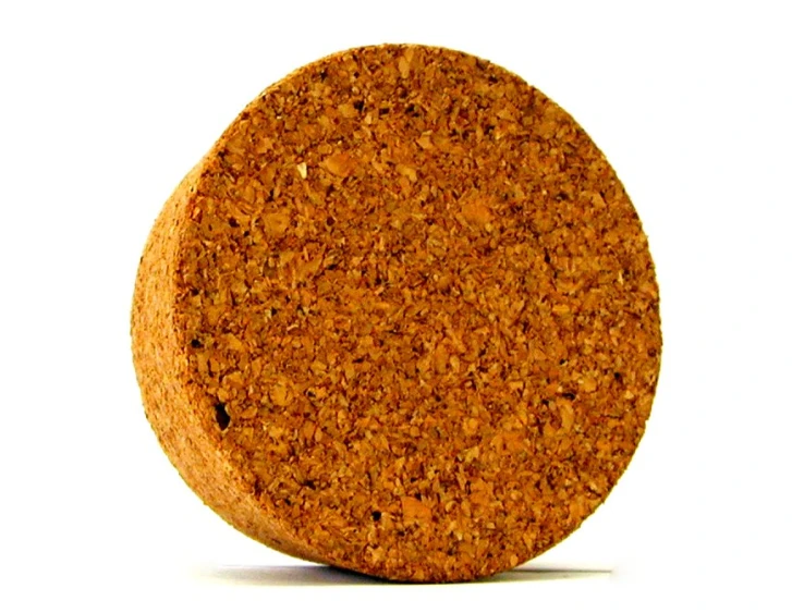 a cork coaster with an orange color and white background