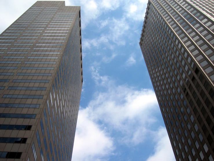 a group of buildings that have some clouds in the sky