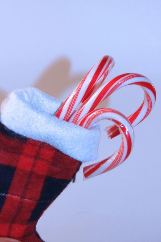 an adorable red and white candy cane holder