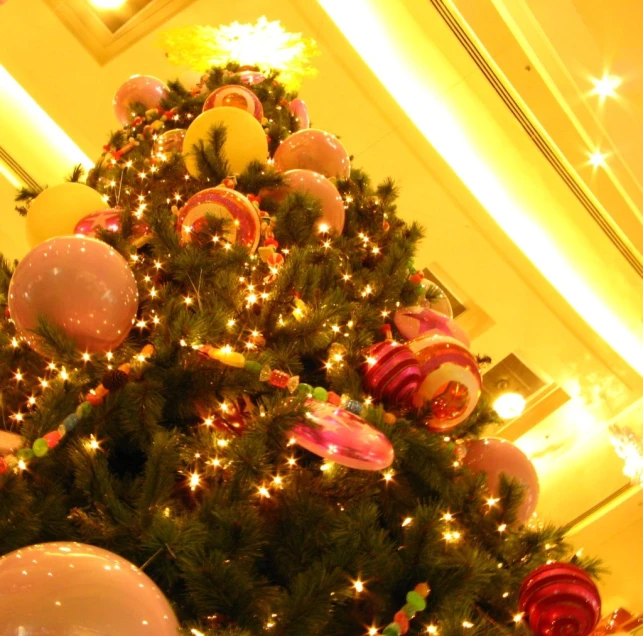 a christmas tree with lots of holiday balloons