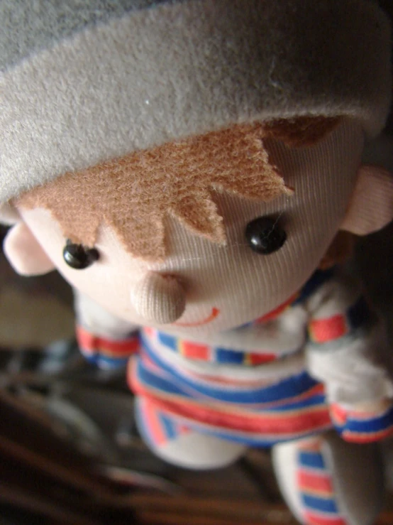 a small stuffed toy that has a hat on