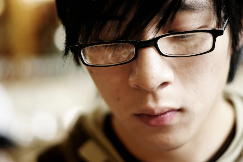 close up of the face of a person wearing glasses